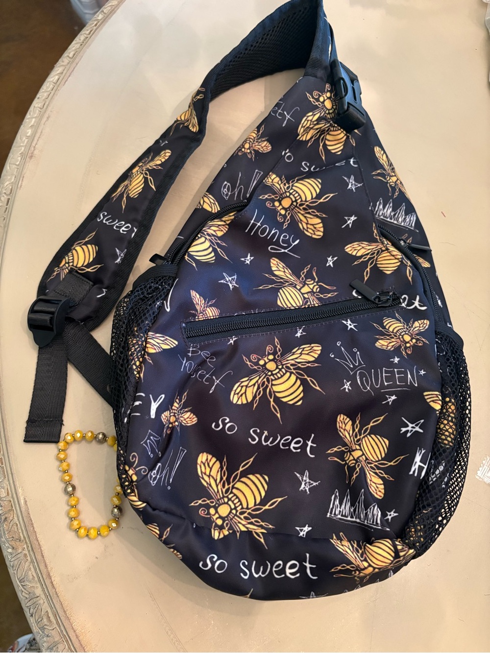 Bee Print Sling Backpack - Black with Yellow Bee Motif